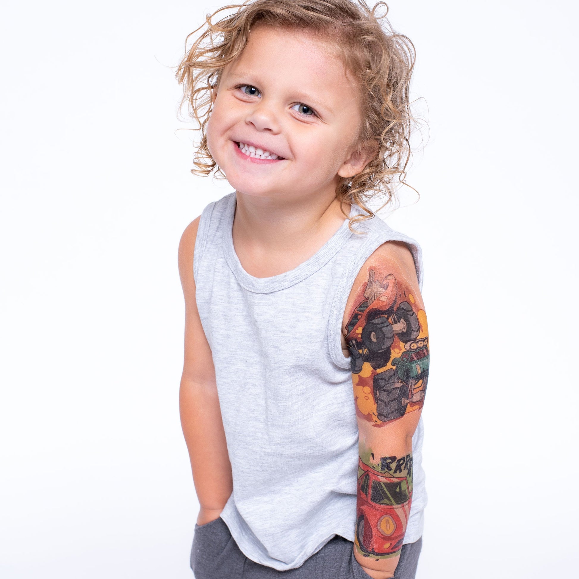 Temporary kids tattoo sleeve on arm, showing multi-color big-wheel scene