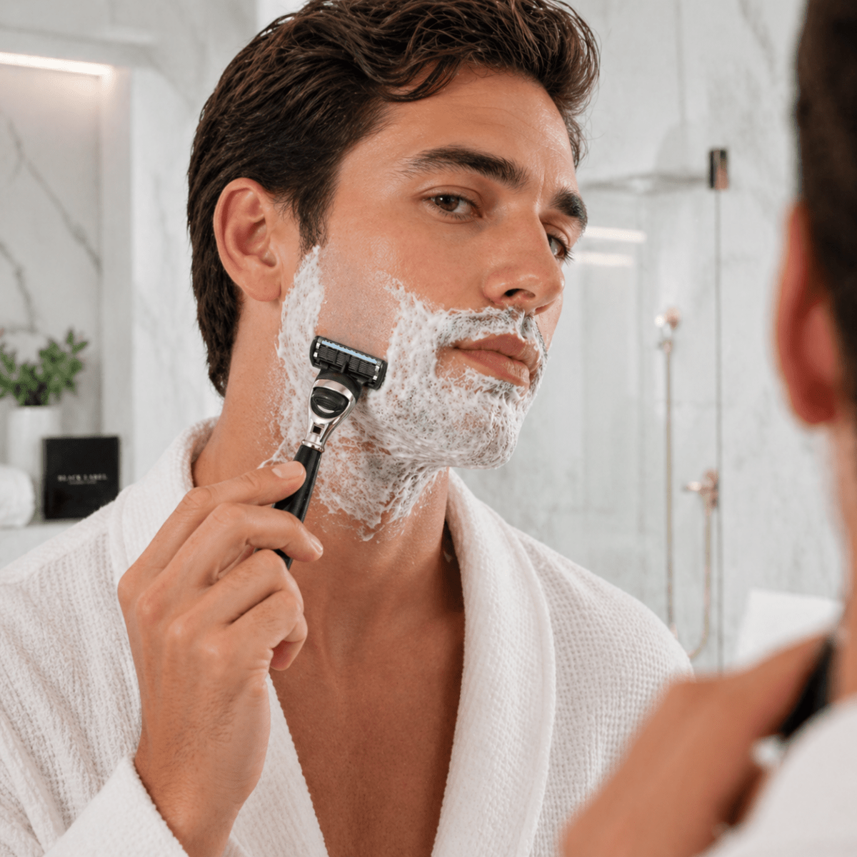 5-blade razor cartridge with shaving foam, used for facial shaving