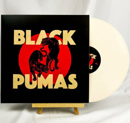 Vinyl record and sleeve with bold logo, black/red puma silhouette and cream disc