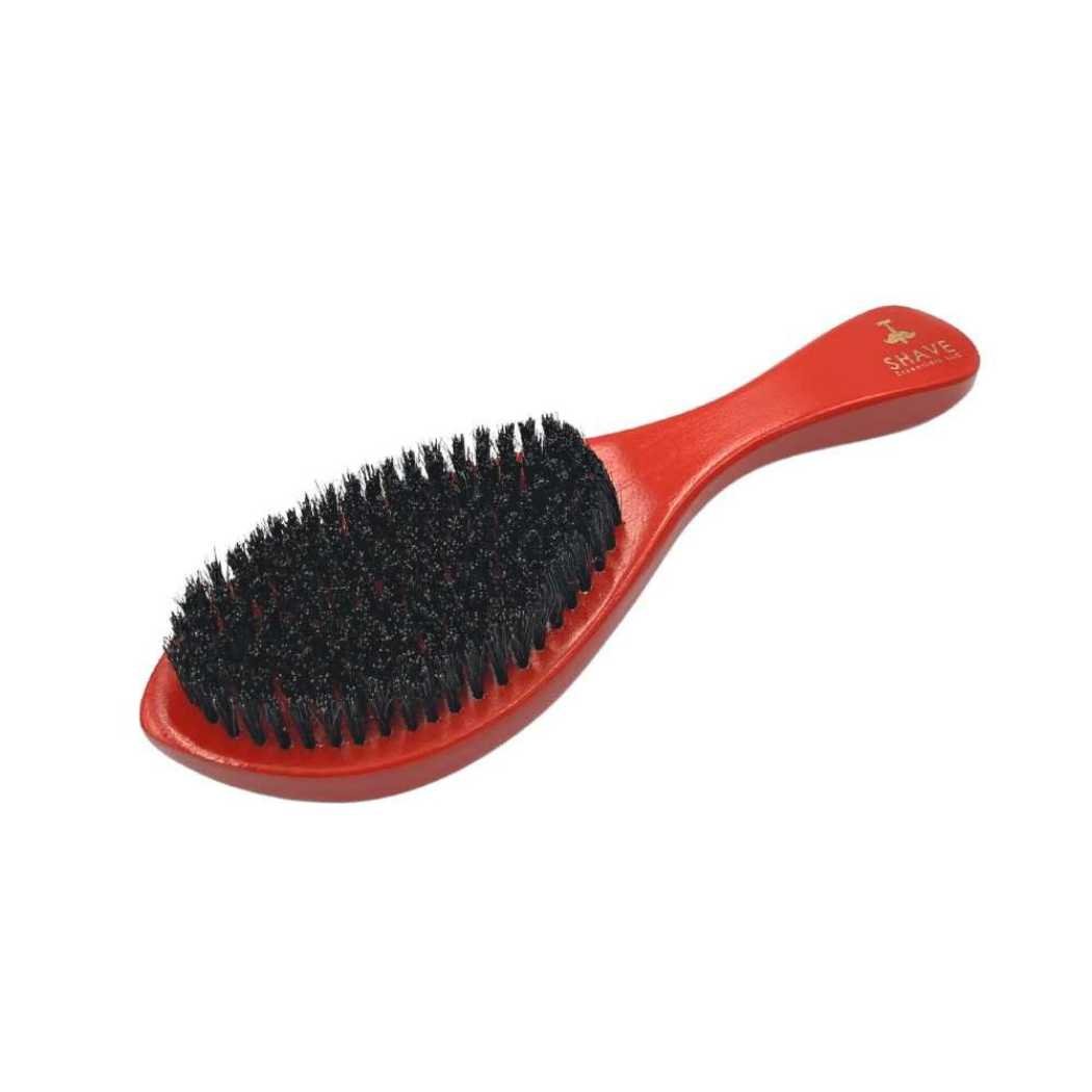 Red boar bristle hair brush with curved handle and dense bristles