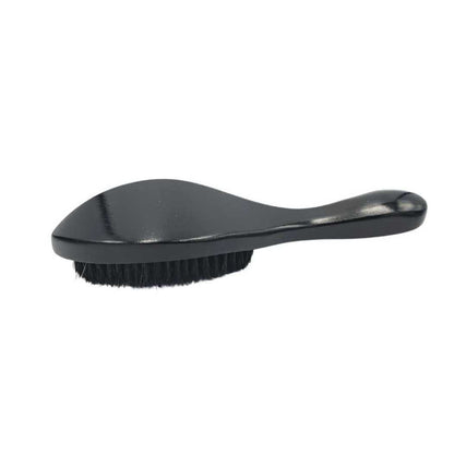 Black boar bristle hair brush with angled handle and dense bristles