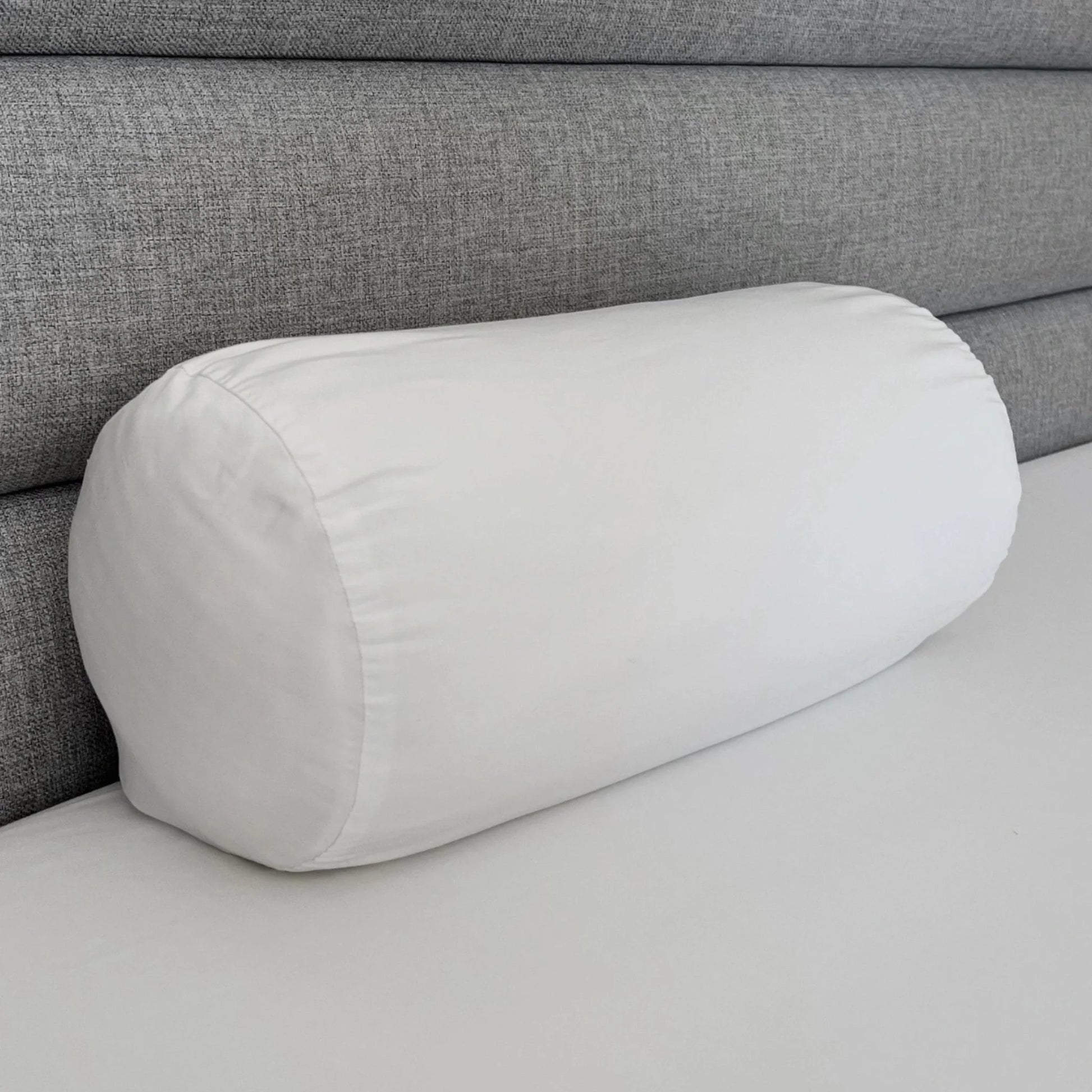 White bolster pillowcase, cylindrical cover with stitched end seams.