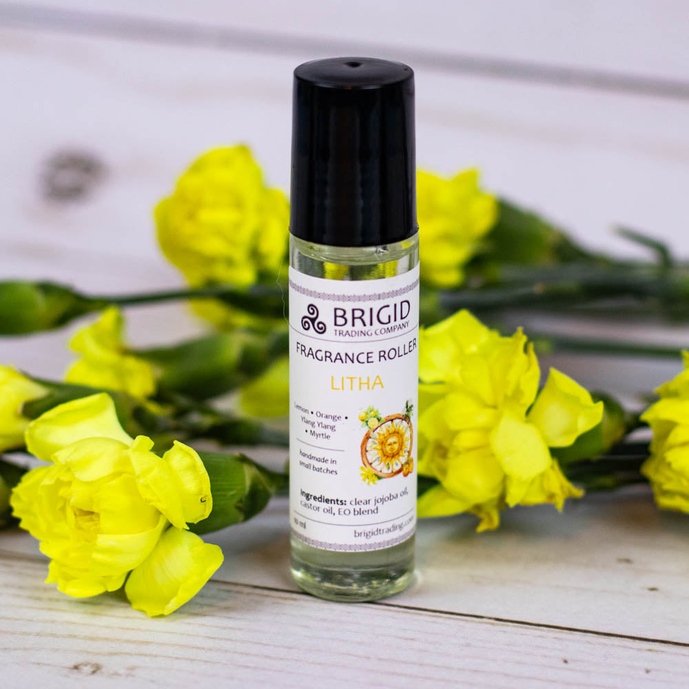 Litha fragrance roller in clear bottle with black cap, labeled Lemon & Orange