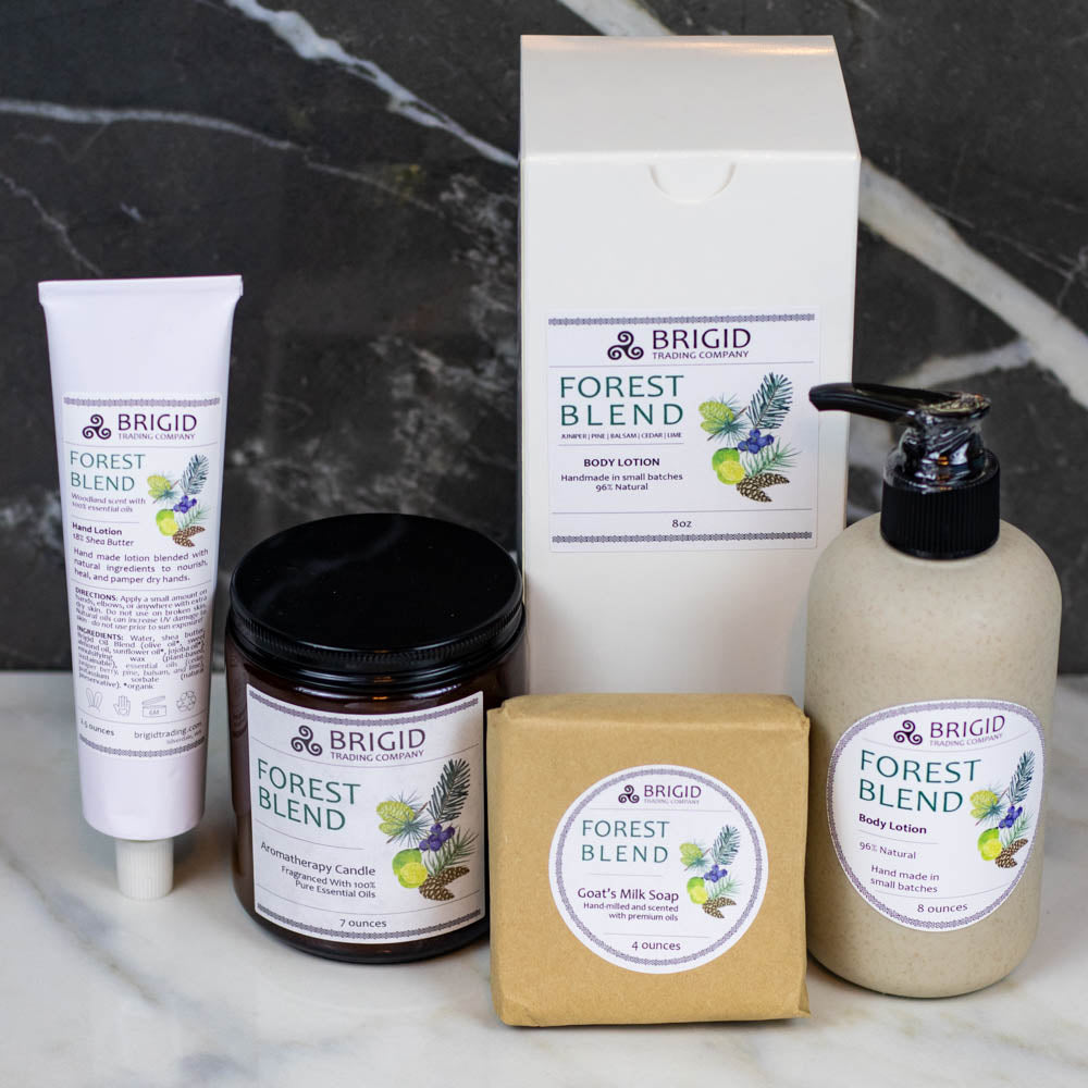 Forest Blend hand lotion tube, jar, pump bottle, and bar soap on marble
