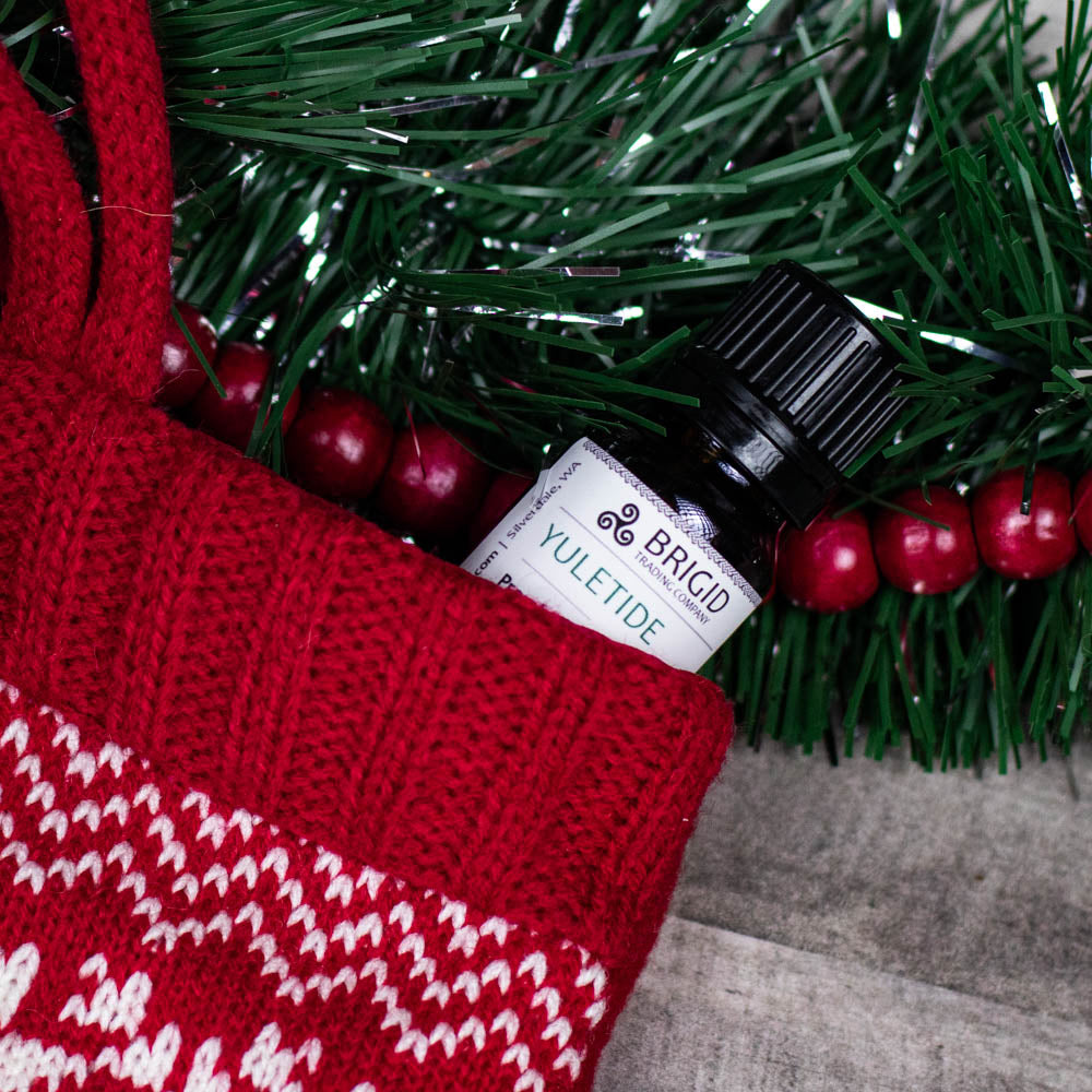 BRIGID oil scent roller bottle labeled YULETIDE
