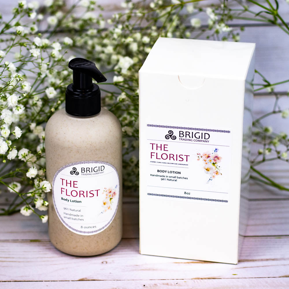 Natural body lotion bottle with black pump next to a white product box