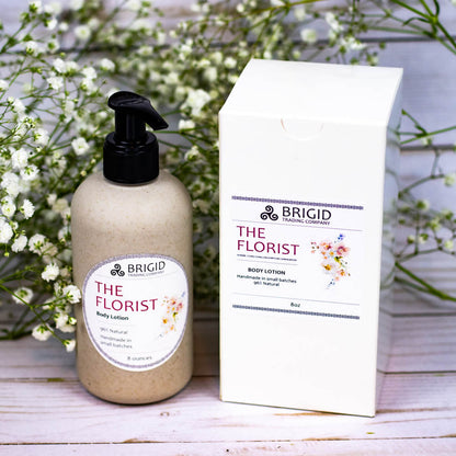 Natural body lotion bottle with black pump next to a white product box