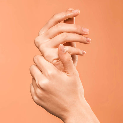 Natural hand lotion applied to hands, with product visible on fingertips