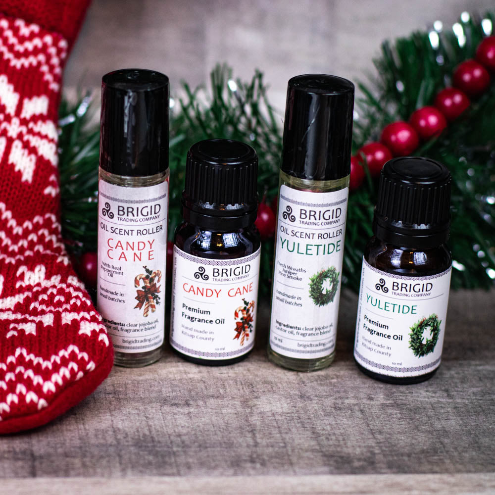 Set of fragrance oil bottles with black caps, including a YULETIDE bottle