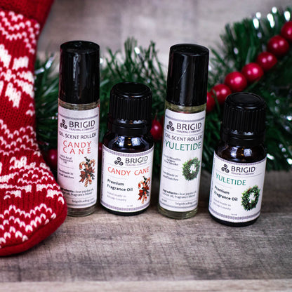 Set of fragrance oil bottles with black caps, including a YULETIDE bottle