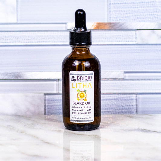 Litha beard oil bottle with dropper, amber liquid, lemon and orange label