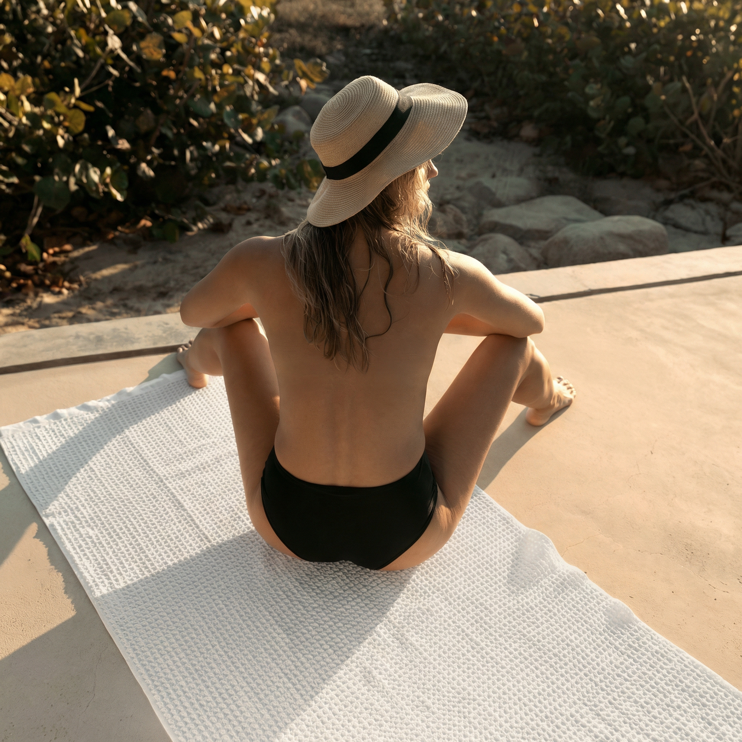 White waffle weave towel laid out flat, textured square pattern and folded corner