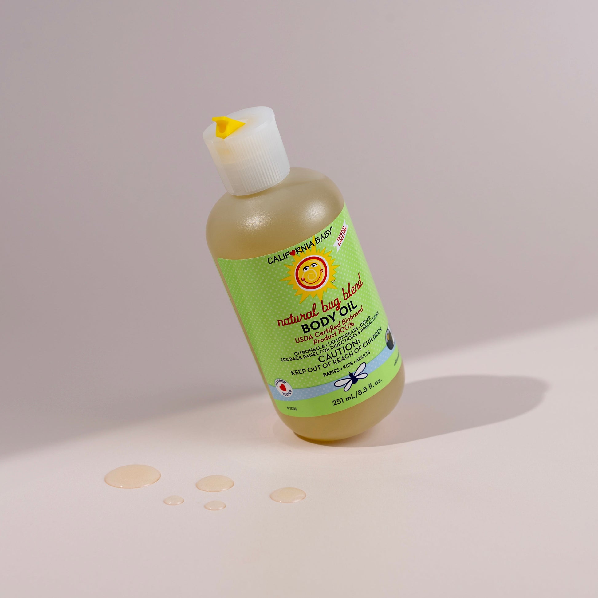 Bug Blend body oil bottle with flip-top cap, green label, pale yellow liquid