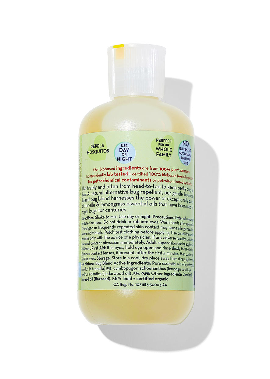 Bug Blend body oil bottle with clear pump and green back label text, pale yellow liquid