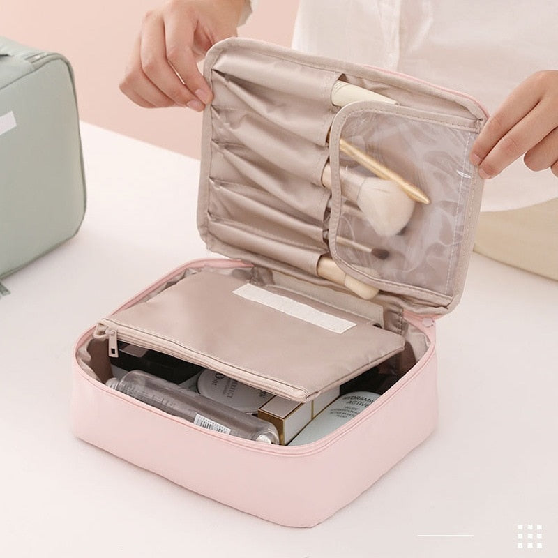 Pink cosmetic bag open with inner compartments and zip pouch organizer