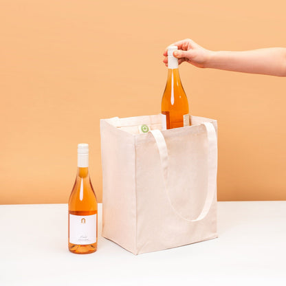 Canvas wine tote bag with loop handles, holding bottles and wine glasses.