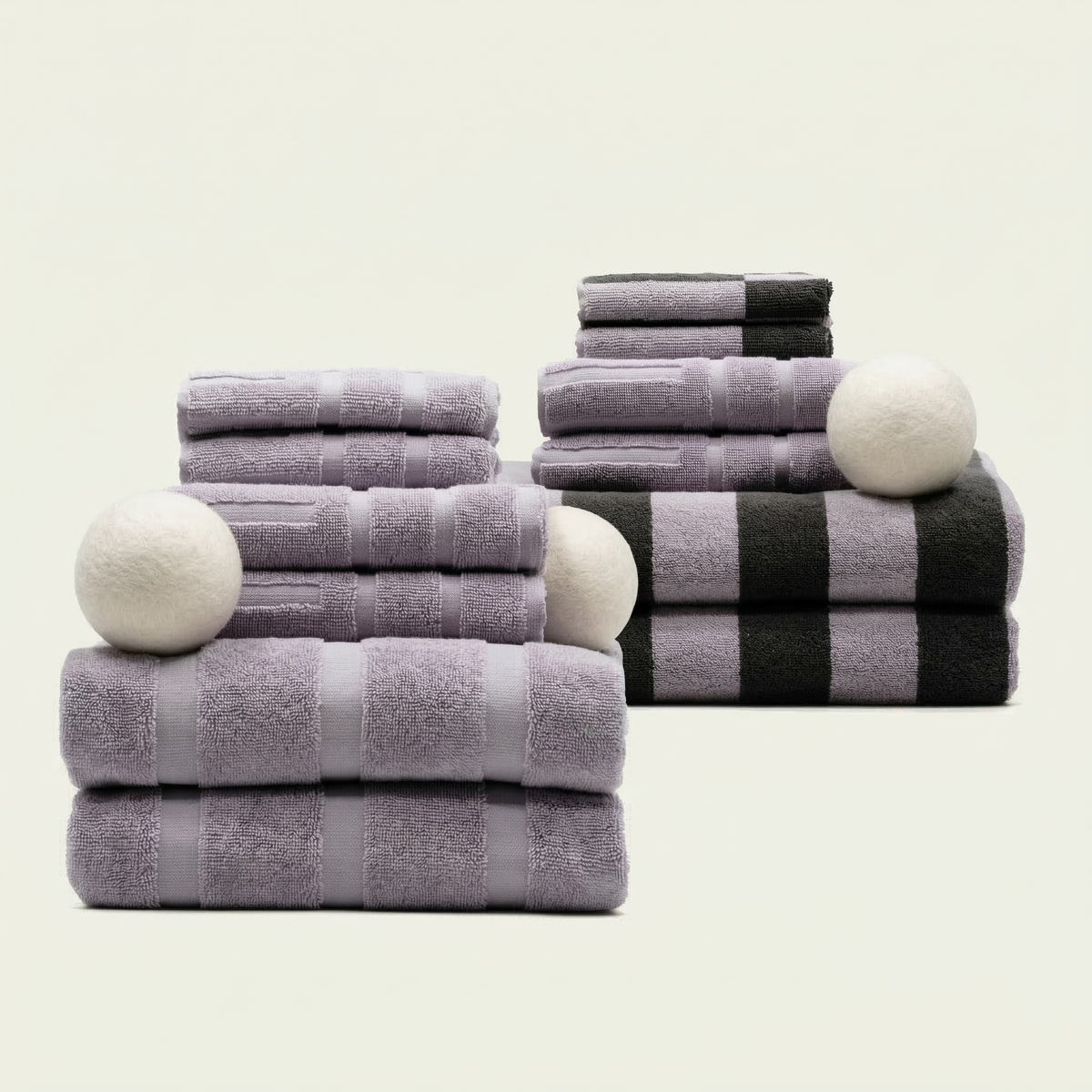 Cotton towels in lilac and dark gray with striped bath and folded hand towels
