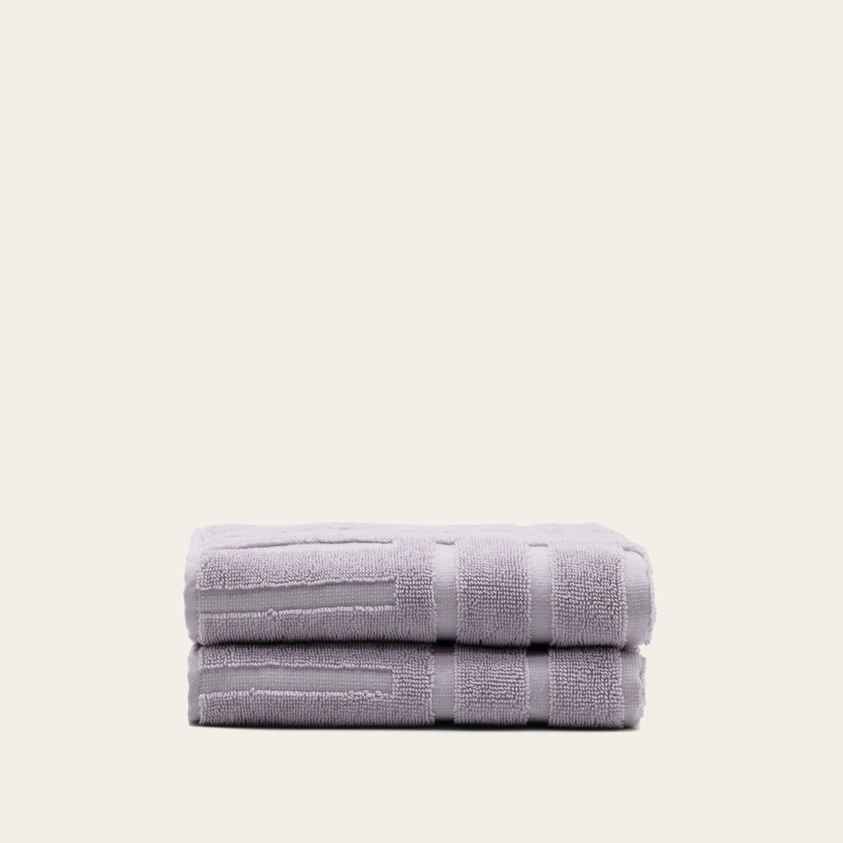 Lilac cotton bath towel, folded with terry texture and horizontal bands