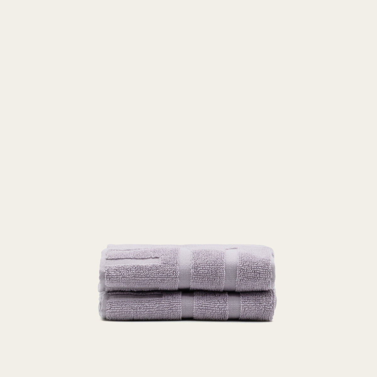 Lilac cotton bath towel set, folded stack with textured terry loops