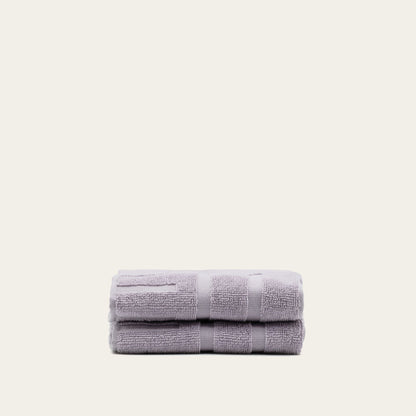 Lilac cotton bath towel set, folded stack with textured terry loops