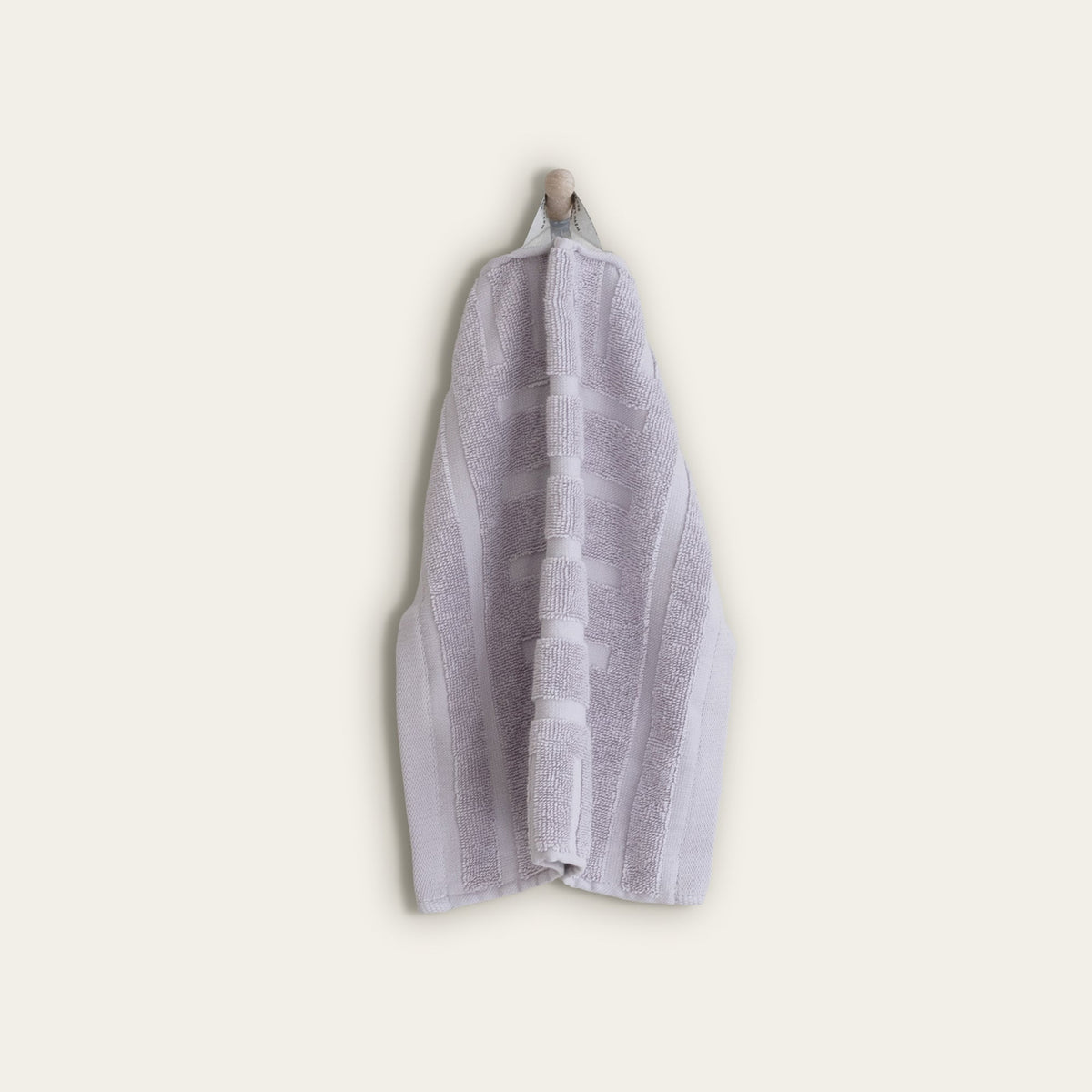 Lilac cotton hand towel, folded with jacquard striped band detail