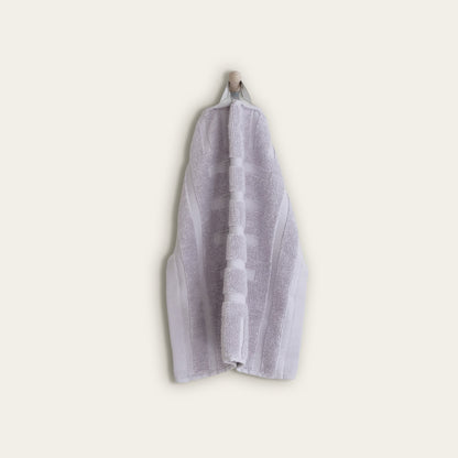 Lilac cotton hand towel, folded with jacquard striped band detail