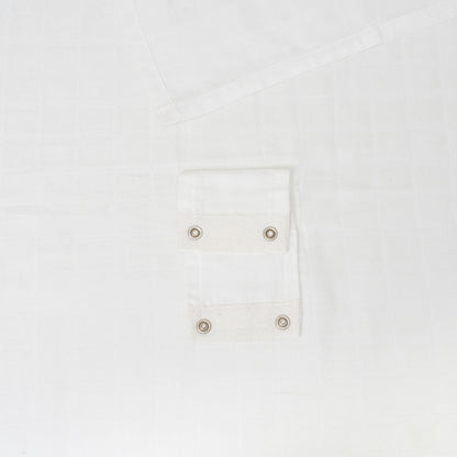 Muslin car seat cover in white with snap-button pocket detail