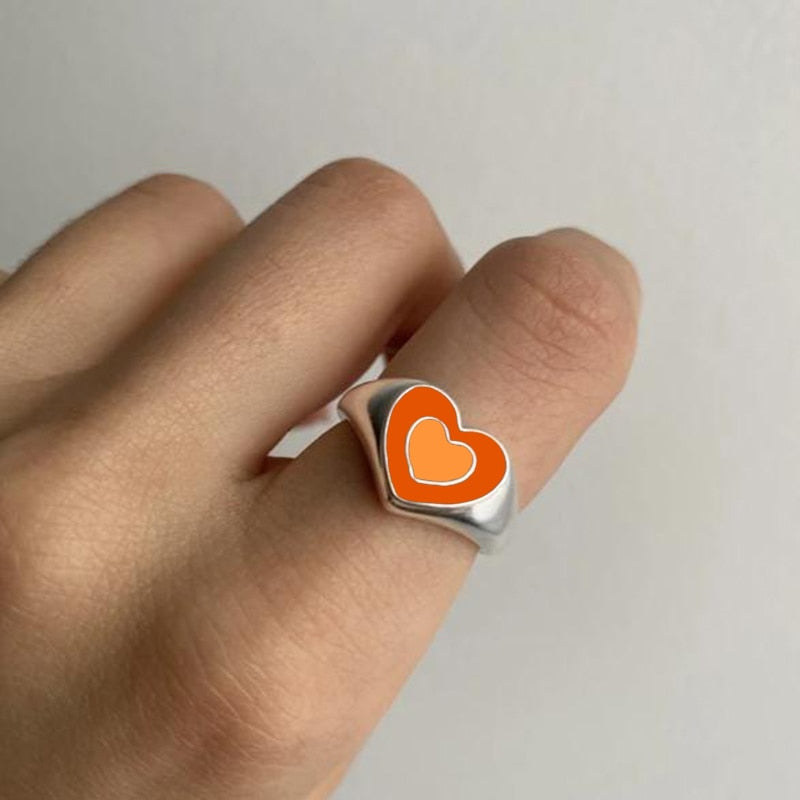 Love heart ring with orange enamel heart and white outline on silver band