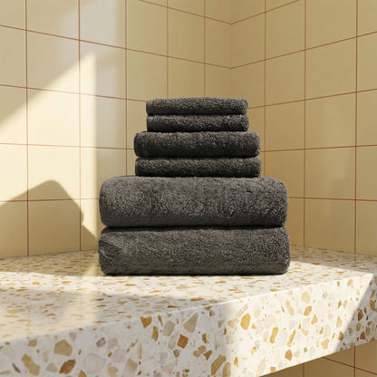 Charcoal plush towels stacked neatly, soft terry loop fabric