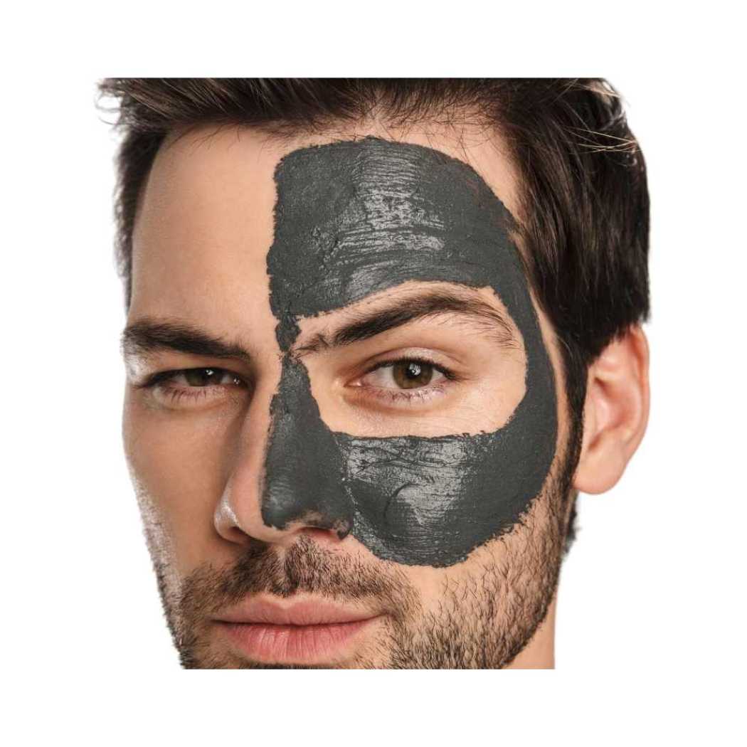 Dark gray clay mask spread over face