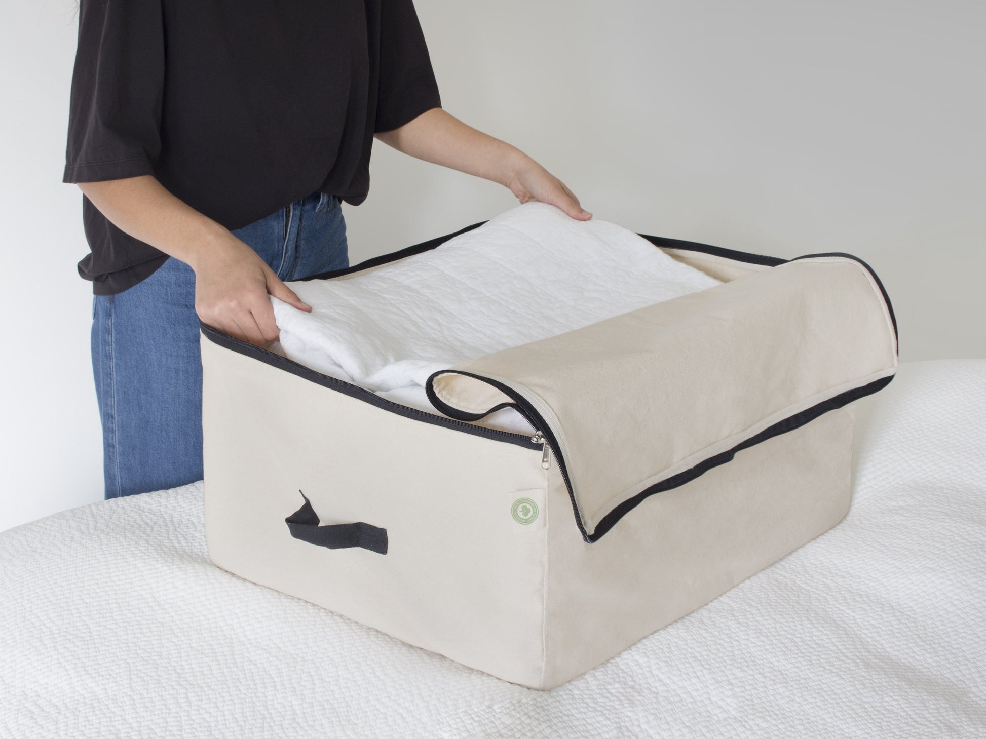 Comforter storage bag, beige fabric with black zipper and side handle loops