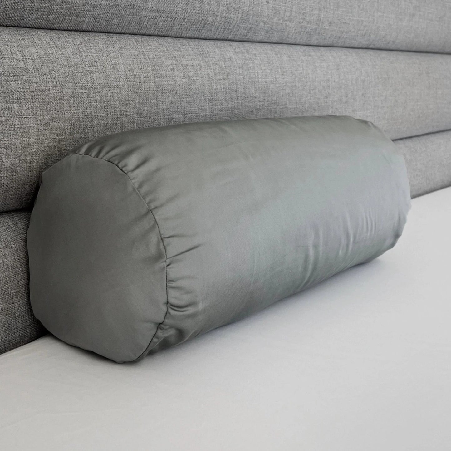 Light gray bolster pillowcase, side view with stitched edge and seam lines.