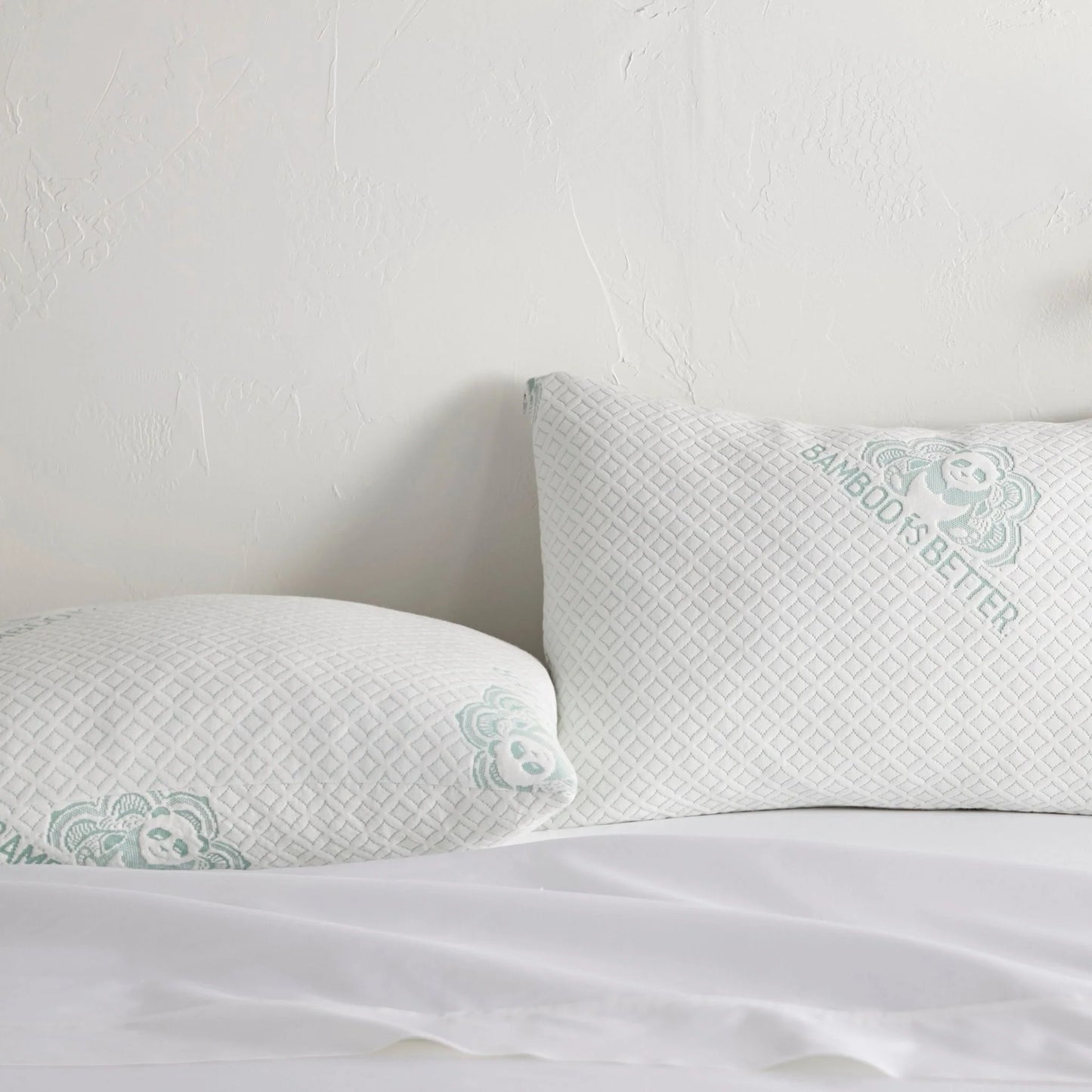 Adjustable cooling pillow with white cover and mint patterned trim for neck support