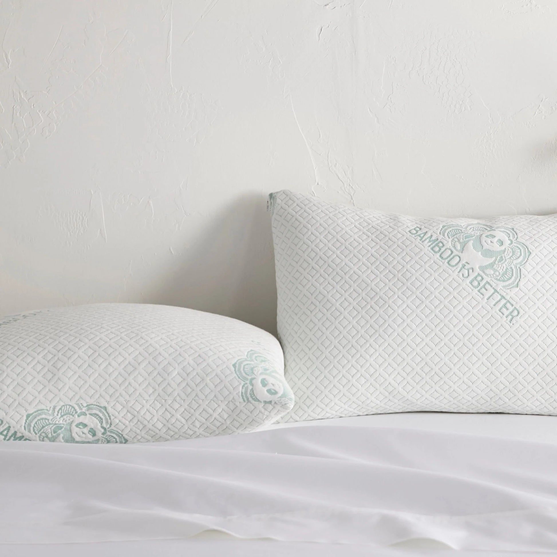 Adjustable cooling pillow with white cover and mint patterned trim for neck support