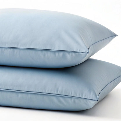 Dusty blue bamboo pillowcase set with matching smooth pillows and piped seams
