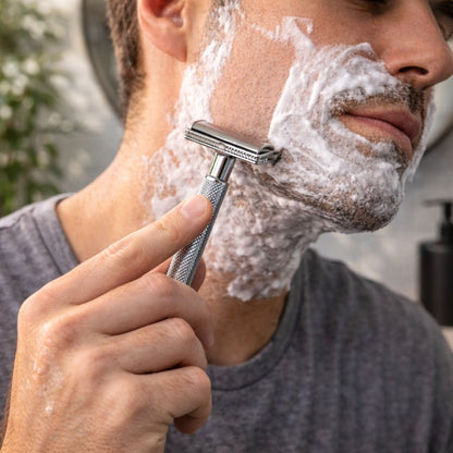 Cooling shave cream foam applied to face with a razor for shaving