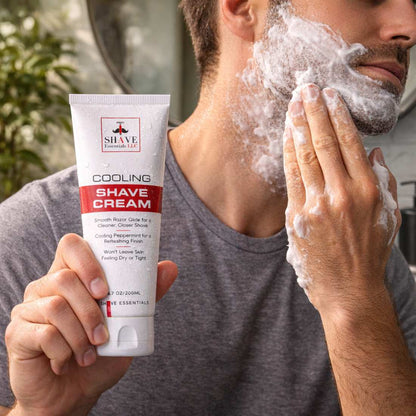 Cooling shave cream tube held in hand with shaving foam on face