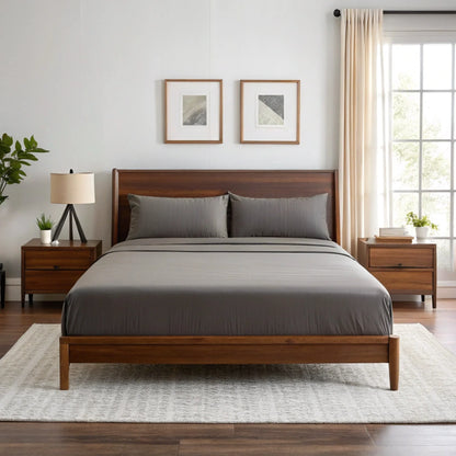 Graphite gray sheet set with two pillowcases and fitted sheet on a bed.