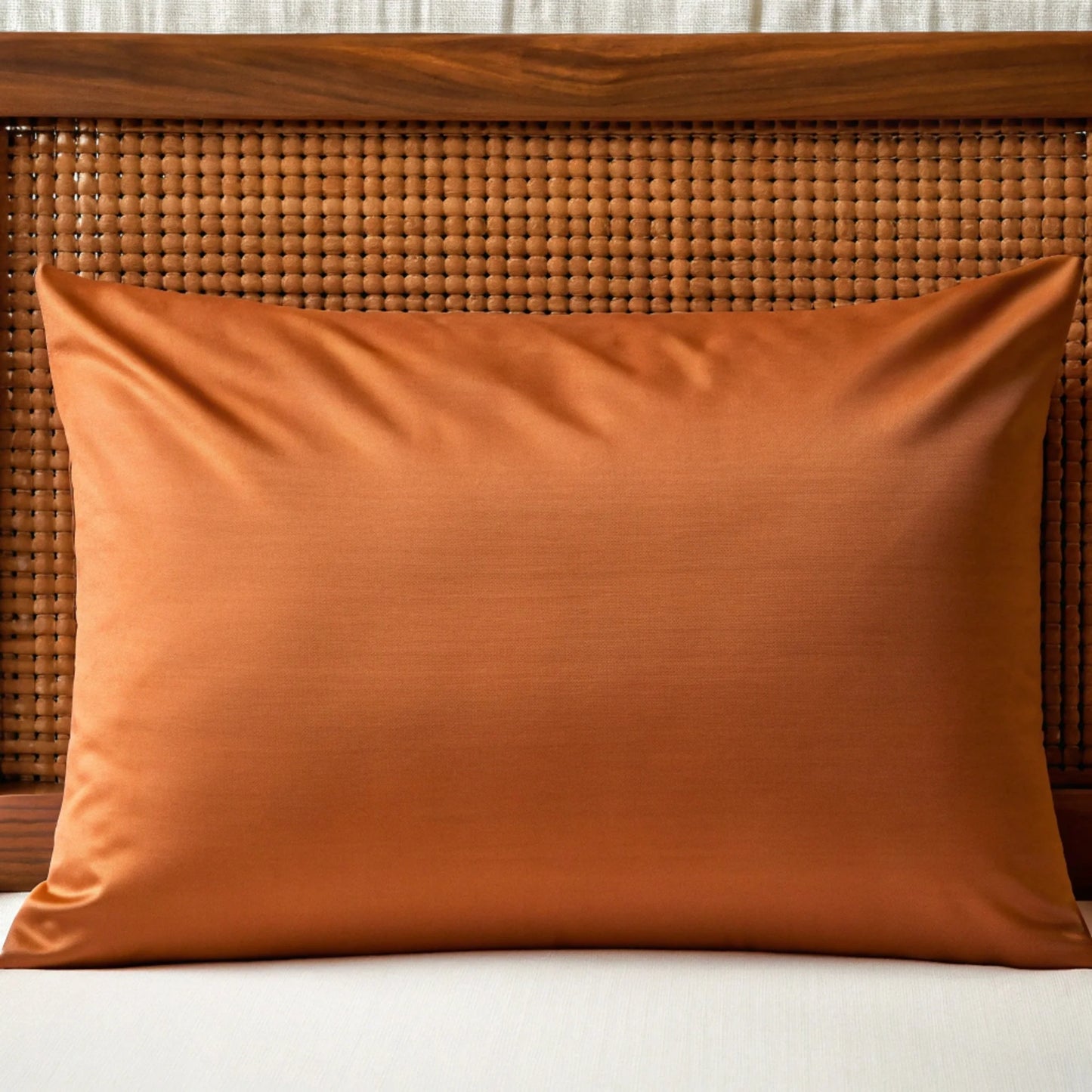 Rust-colored bamboo pillowcase with smooth woven texture and piped edge