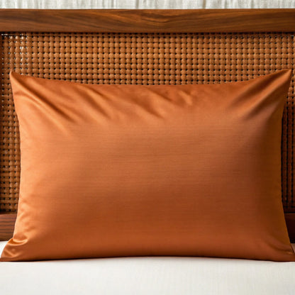 Rust-colored bamboo pillowcase with smooth woven texture and piped edge