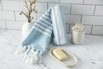Turkish beach towel, light blue striped with tassel fringe and folded edge