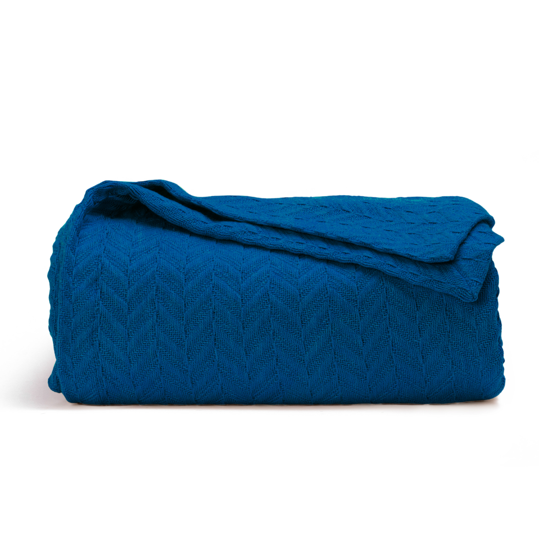 Herringbone cotton blanket, blue, folded with folded top and chevron knit texture