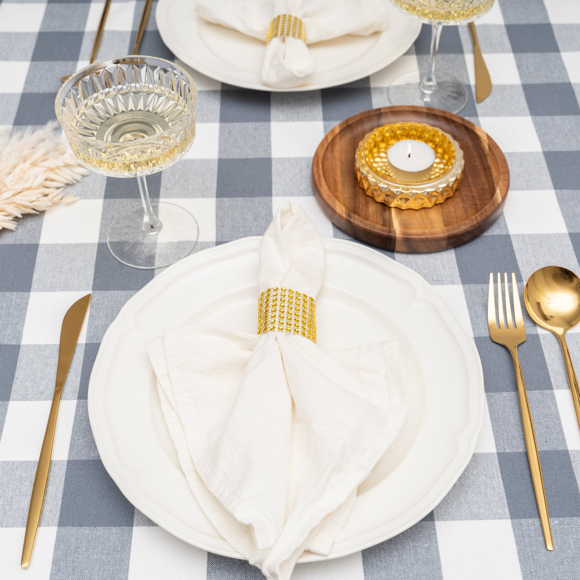 Gray and white plaid tablecloth with place settings and folded napkins