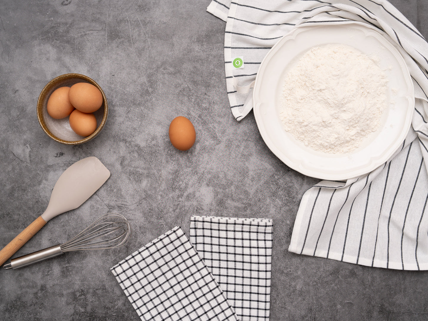 Kitchen towel set: folded check and striped towel pieces in white with black lines