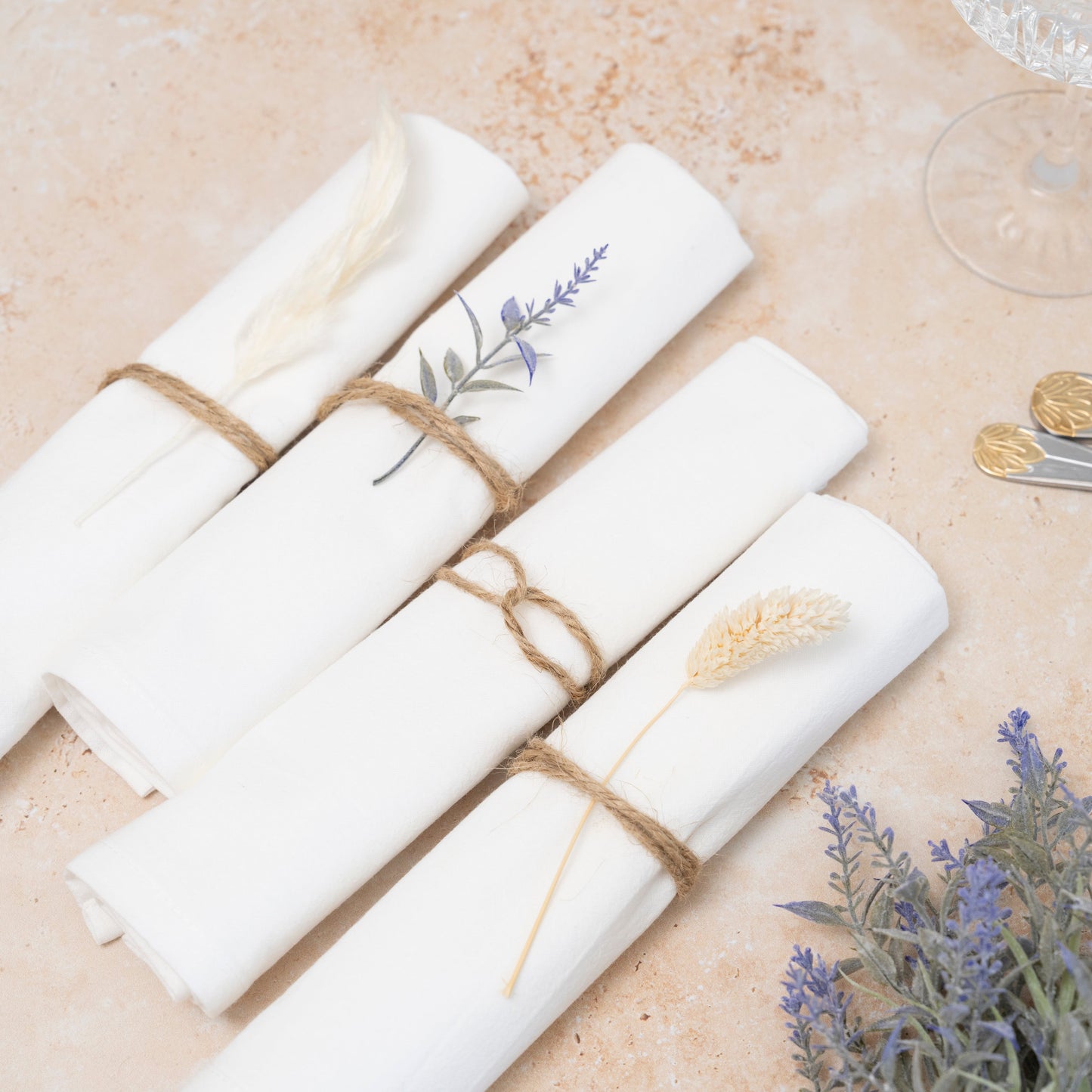 Flour sack napkins, white, rolled and tied with twine, lavender sprig detail