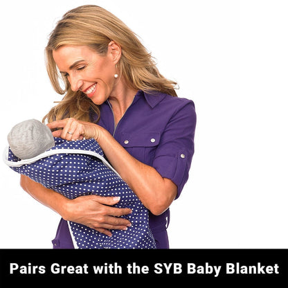 Gray baby beanie worn by baby in blue polka dot blanket