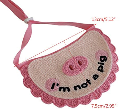 Pink crocheted pet saliva towel with pig face and 'i'm not a pig' patch