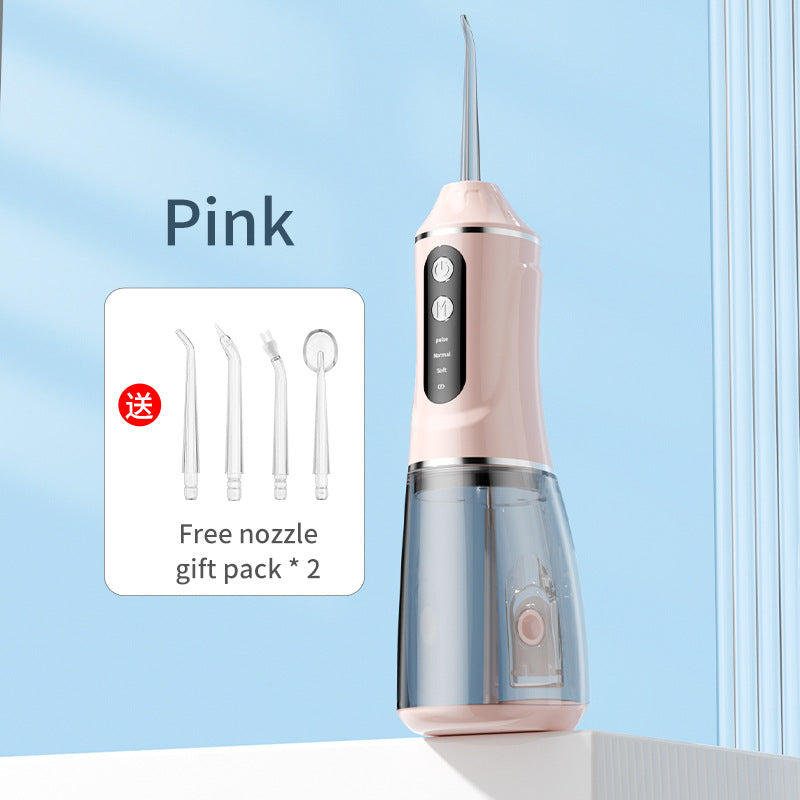 Pink portable electric dental flosser with free nozzle gift pack shown