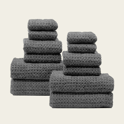 Charcoal waffle towel set with multiple folded towels in different stacks