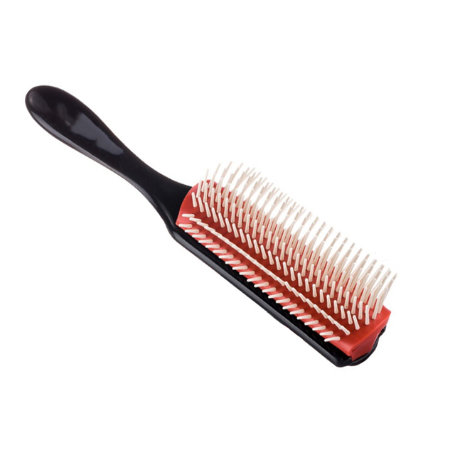 Black massage hair comb with red base and white-tipped bristles